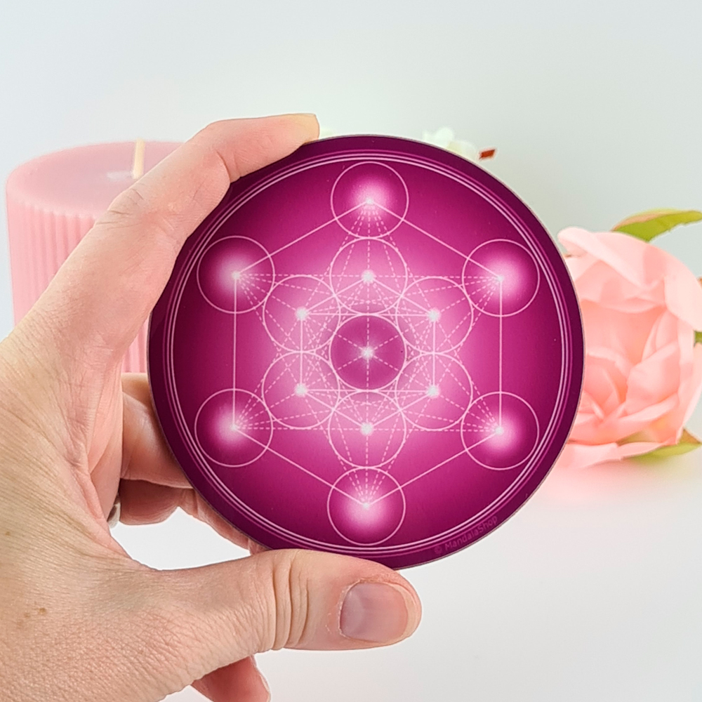 Main tenant un disque violet avec le Cube de Métatron, outil de centrage et d’alignement intérieur dans la pratique de la sagesse incarné