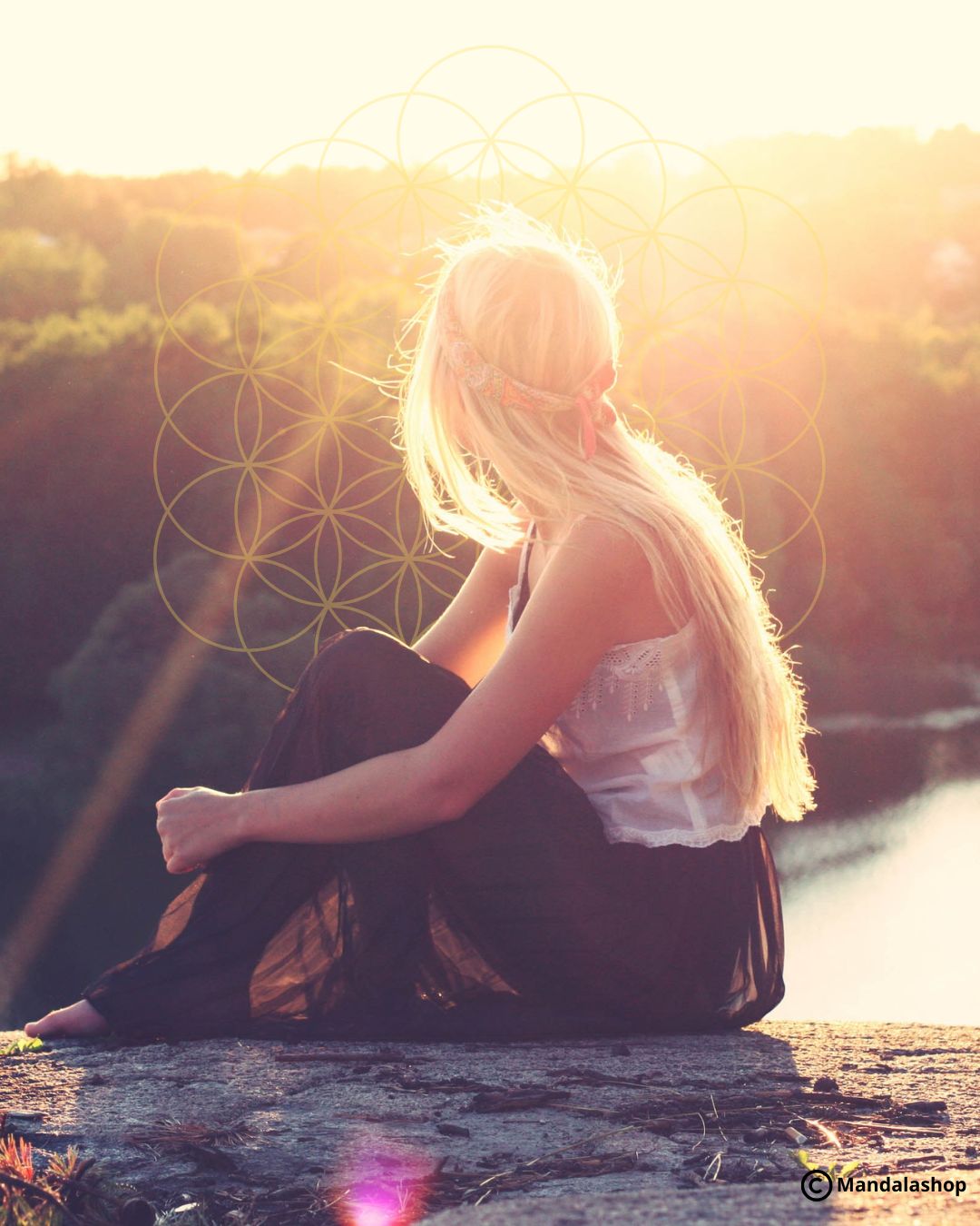 Woman from behind contemplating the landscape at sunrise, with a flower of life in the background, symbolizing a new beginning and inner alignment.