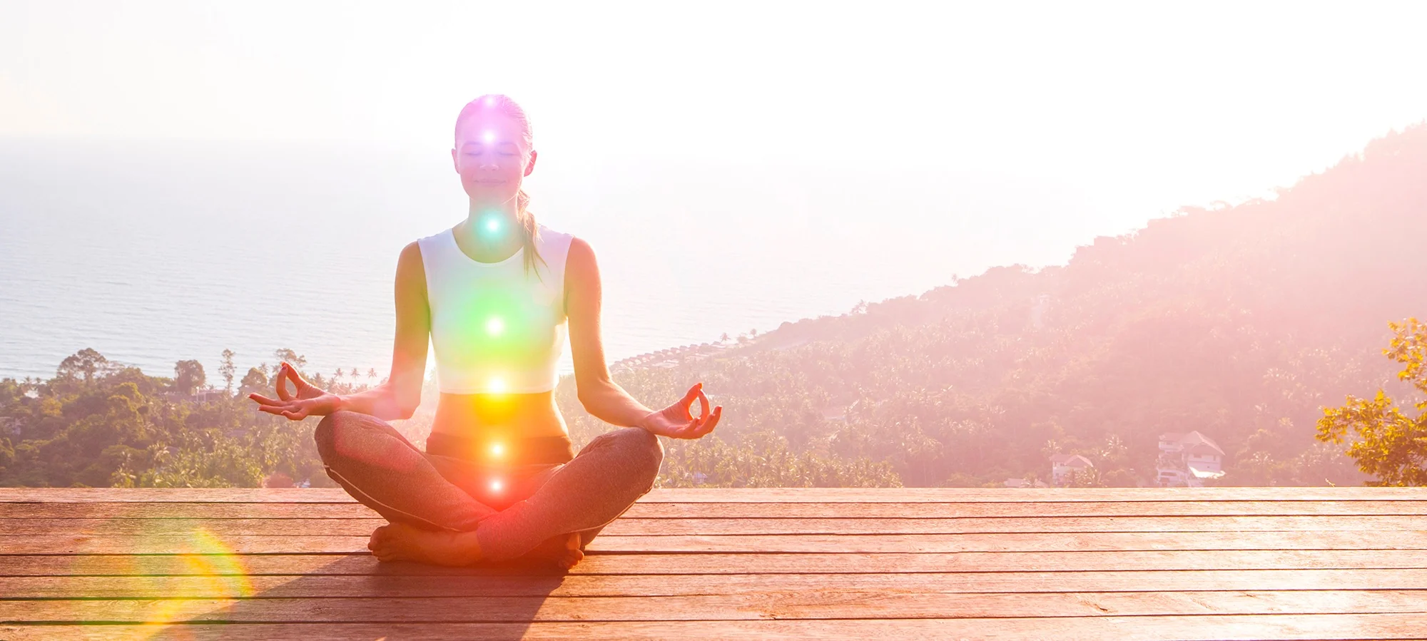 Woman meditating with the 7 chakras aligned, symbol of inner harmony and vibrational elevation