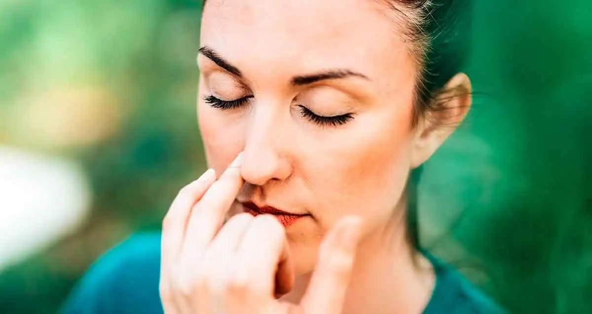 Woman practicing 4-7-8 breathing, a relaxation technique to reduce stress and improve sleep quality
