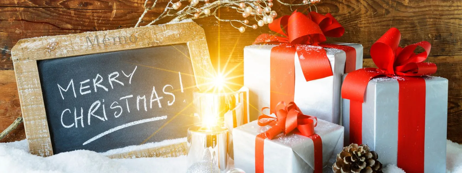 Christmas gifts with a slate reading 'Merry Christmas', symbolizing the spirit of sharing, generosity, and celebrating the holiday