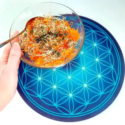 Dish of raw vegetables placed on a blue Flower of Life glass plate, to energize foods and increase their vibrational frequency