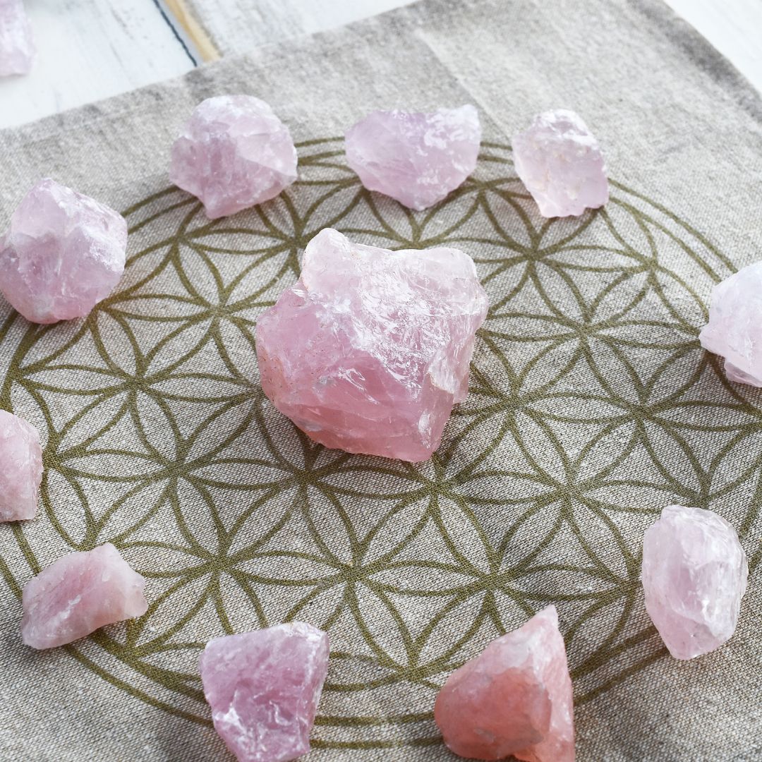 Rose quartz, stone of inner peace, arranged on a Flower of Life - energetic harmony and spiritual serenity