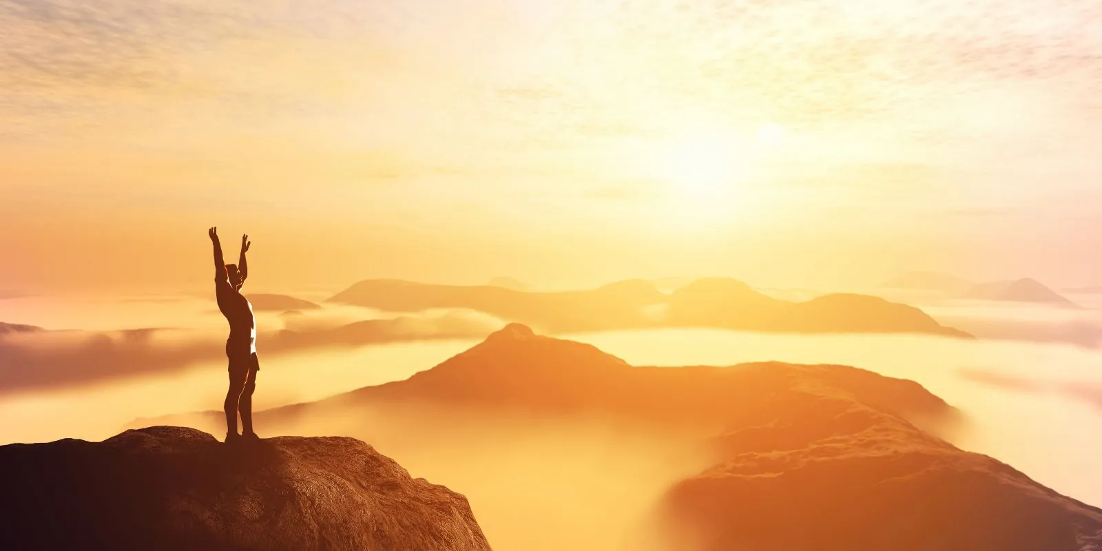 Man on top of a mountain, raising his arms to the sky under the rising sun, symbolizing freedom, optimism, and personal growth